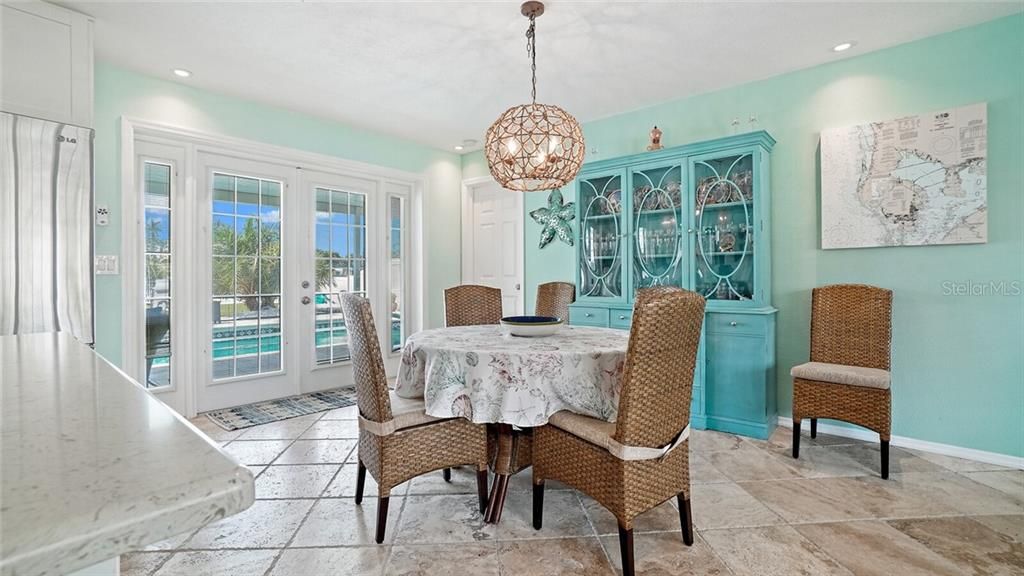 Breakfast bar, second living room, and beautiful French doors to the pool area.