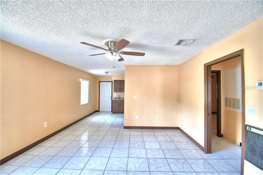 Pocket door on right leads to the hallway, kitchen and back door to the carport are ahead.