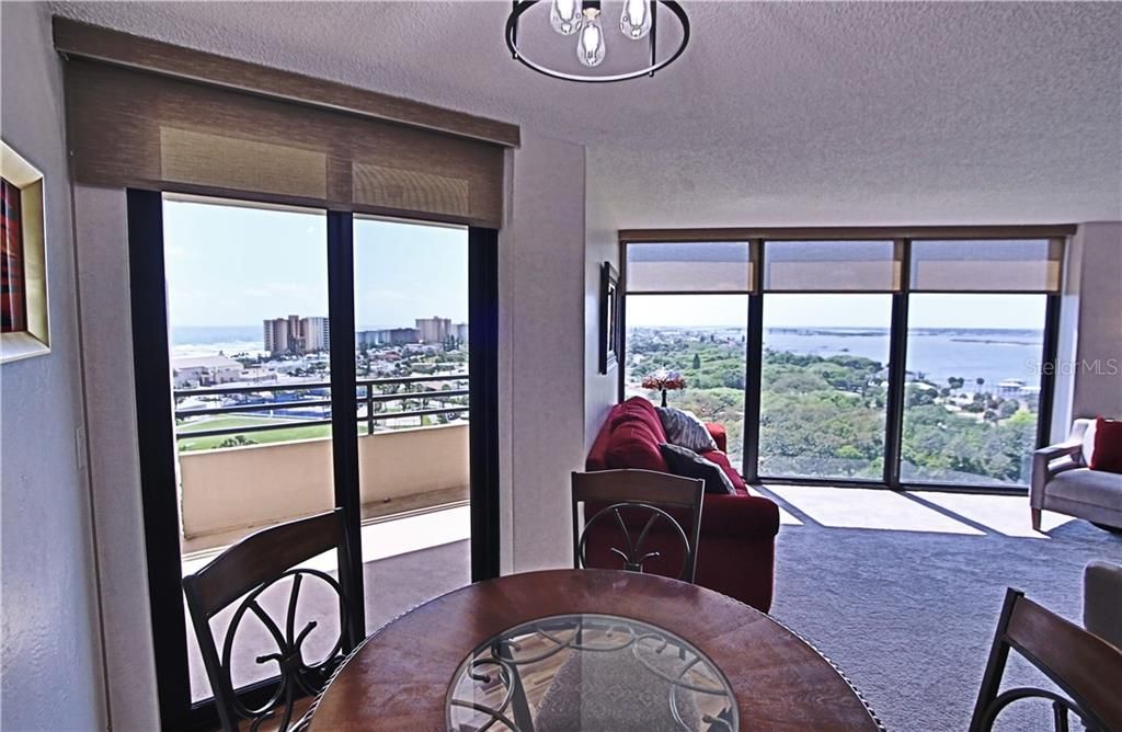 Dining open to Living and Balcony with view of Atlantic to left and view of Halifax River to right.