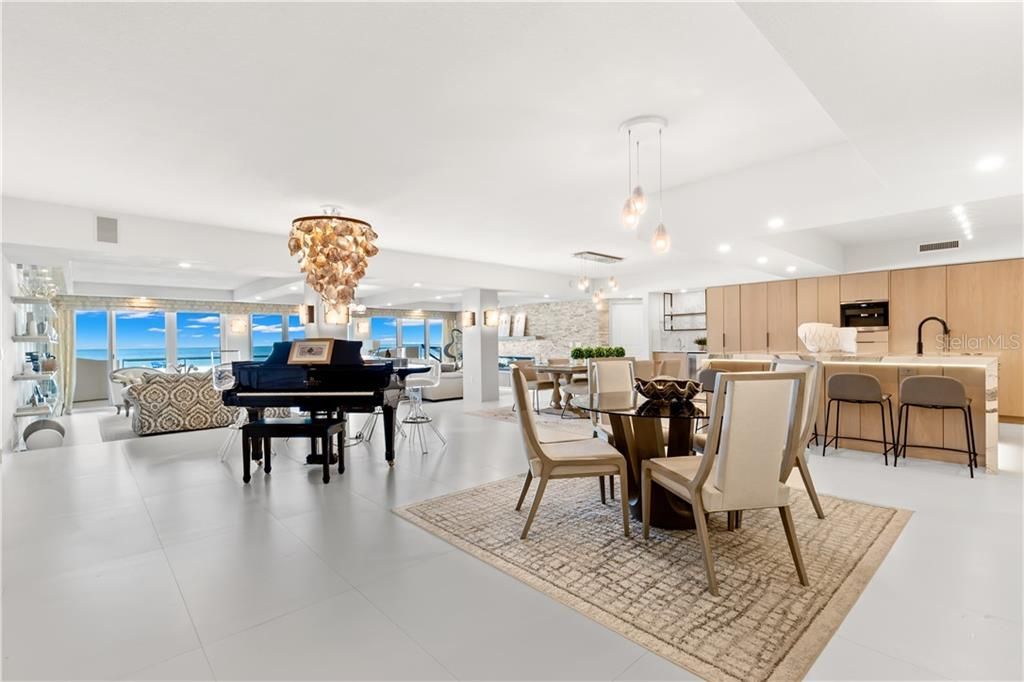 The sophisticated volume coffered ceilings,  4x2 ceramic tile flooring, and open floor plan make the communal space feel even larger.  Natural lighting highlights the clean, modern design.