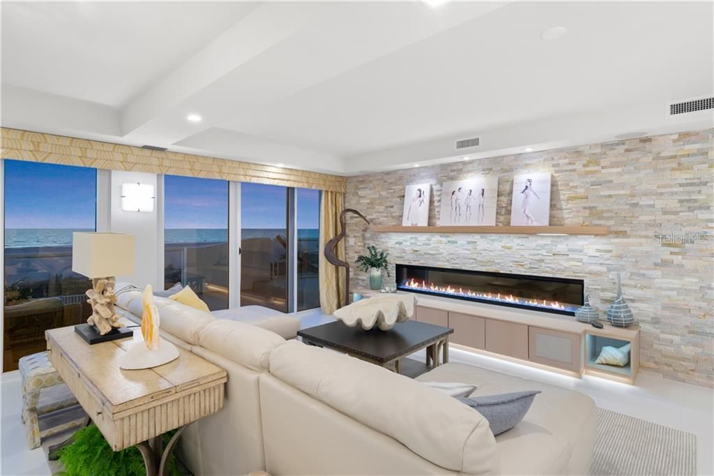 Cozy up next to the modern, electric, linear-design fireplace set against a custom stone wall.