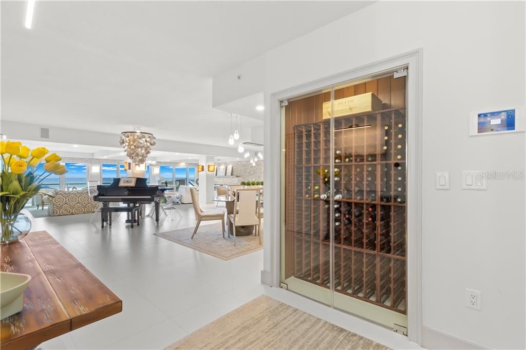 Floor-to-Ceiling windows are the perfect greeting as you enter the unit.  The 220-bottle wine cooler is temperature-controlled and beautifully highlights your collection.