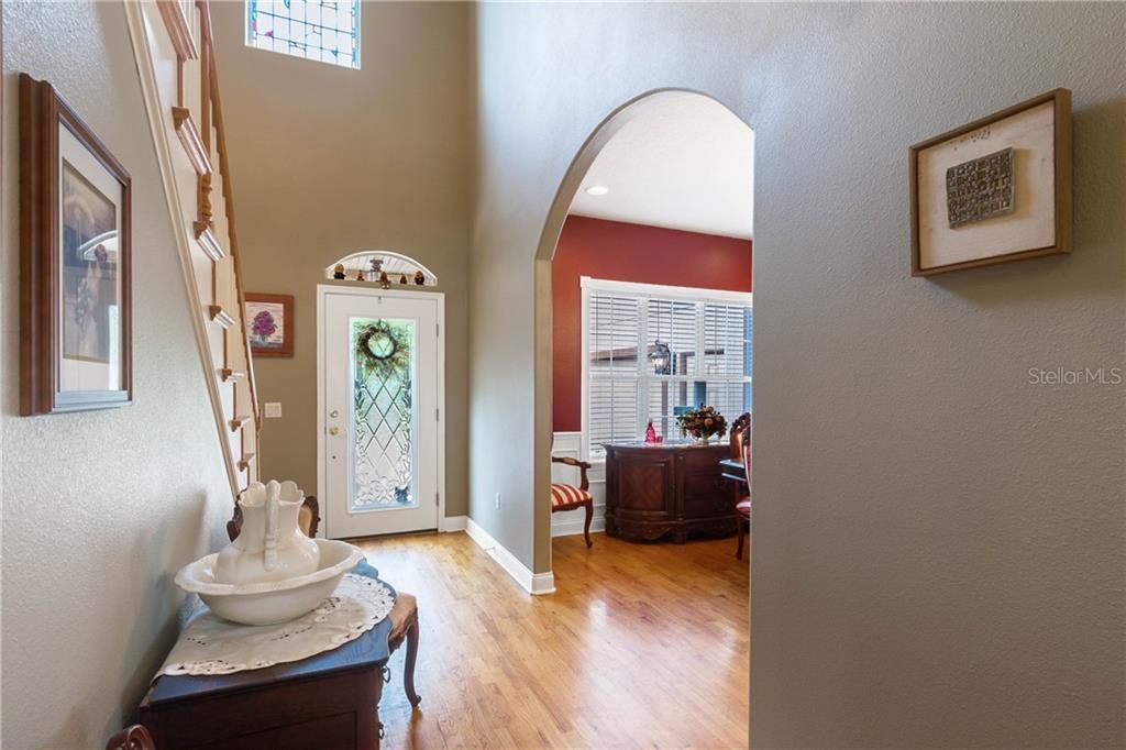 Leaded Glass Front Door and Stain Glass Windows add charm to this Foyer