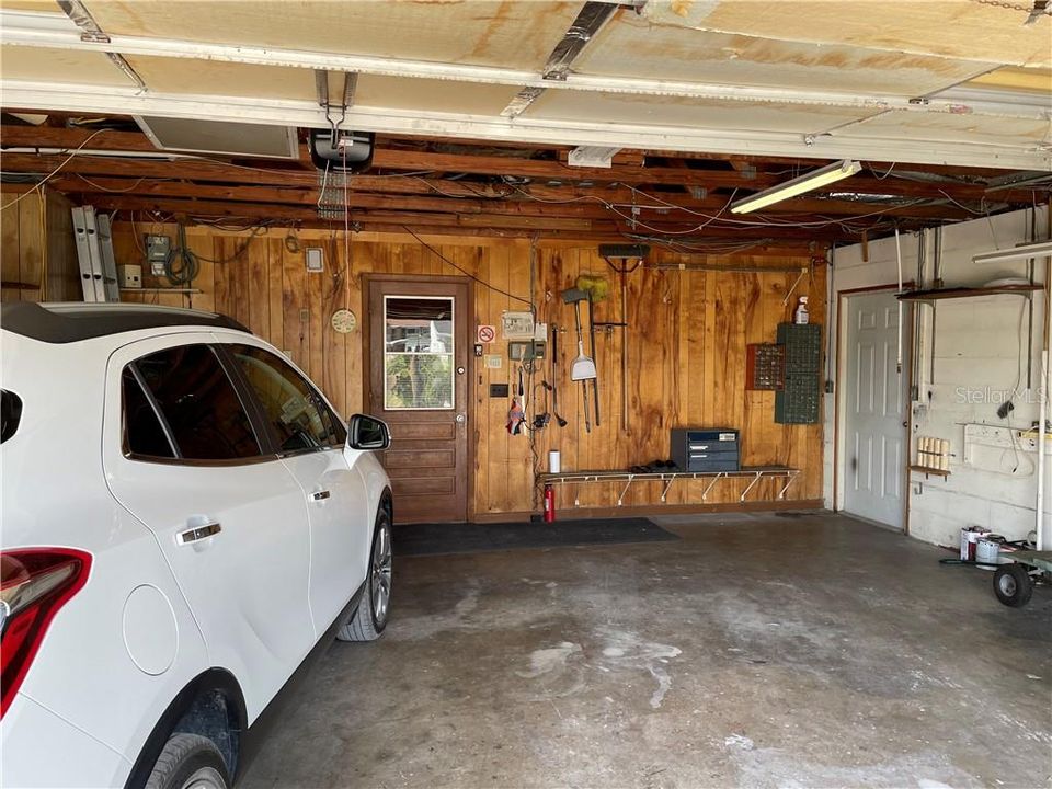 Oversized 2- Car Garage, electric door opener. Shown here door to house and door to extra building with A/C