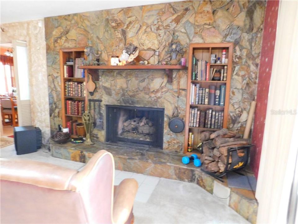Portion of Great room showing the stone faces wall and gas Fireplace