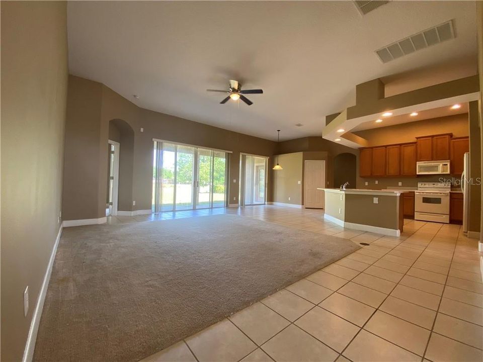 Large open living room. Two sets of sliding doors.