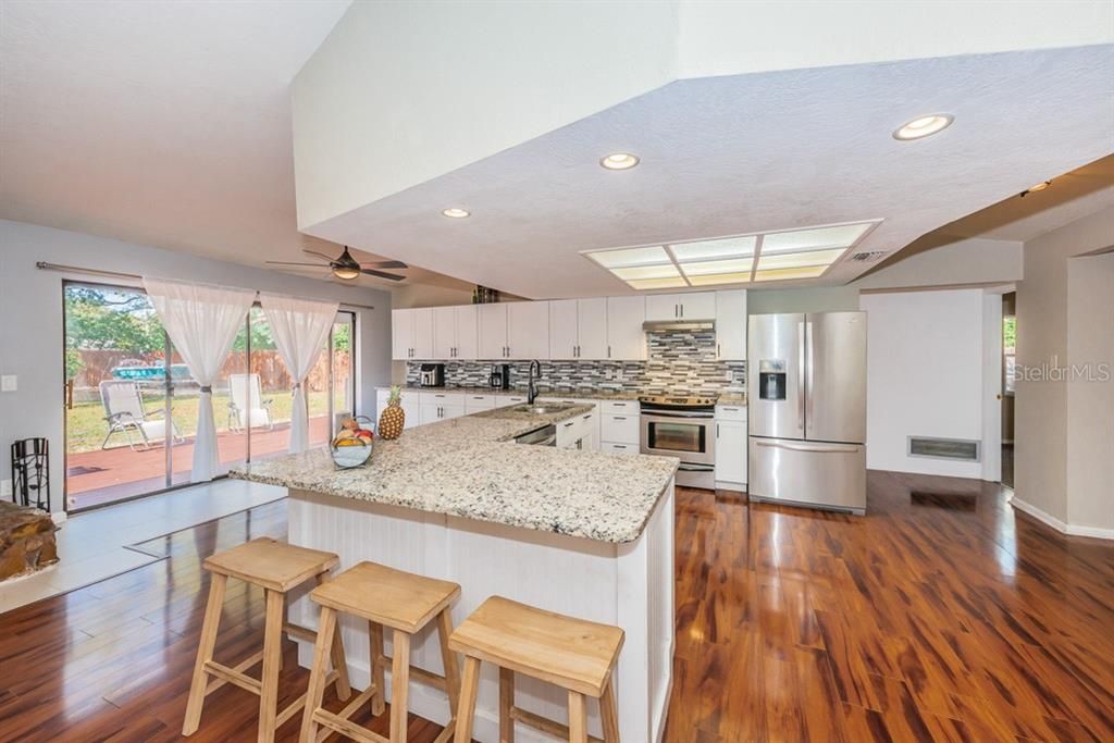 Incredible kitchen features shaker cabinets, granite counters and stainless appliances.