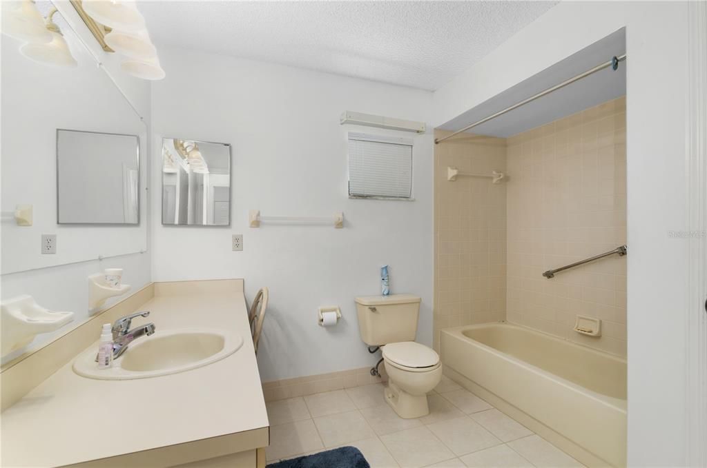 Guest Bath with Shower/Tub, LARGE vanity, linen closet and commode.
