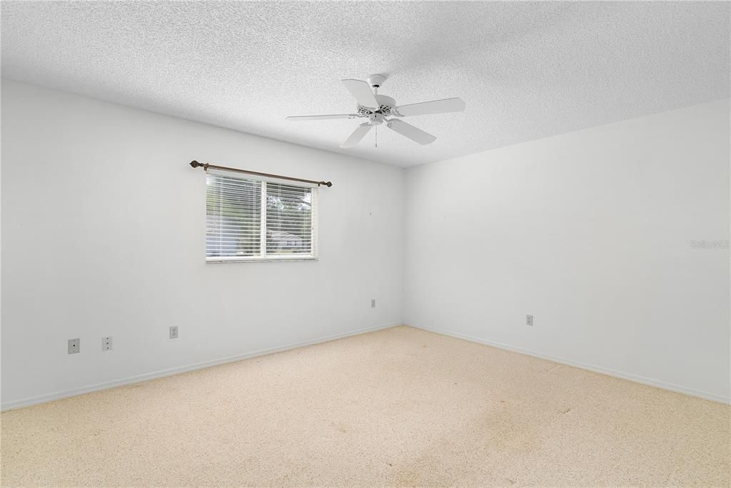 Guest Bedroom. Ceiling fan, carpet flooring and WALK-IN closet.