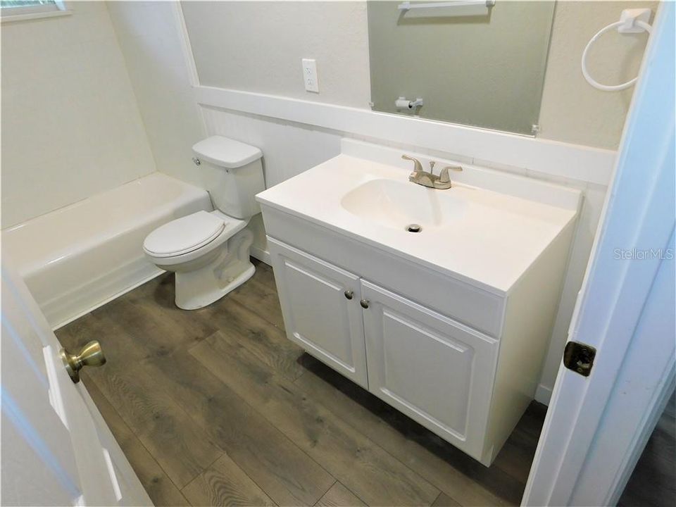 guest bathroom with tub/shower new vanity and toilet