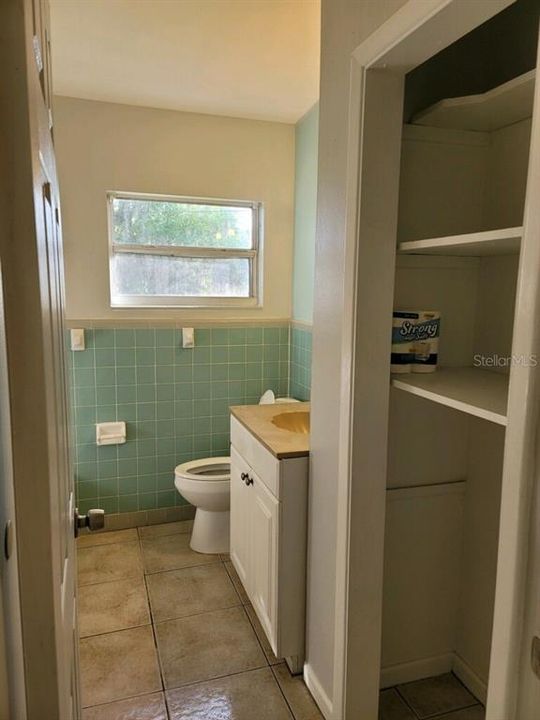 Bathroom with closet for towels and storage
