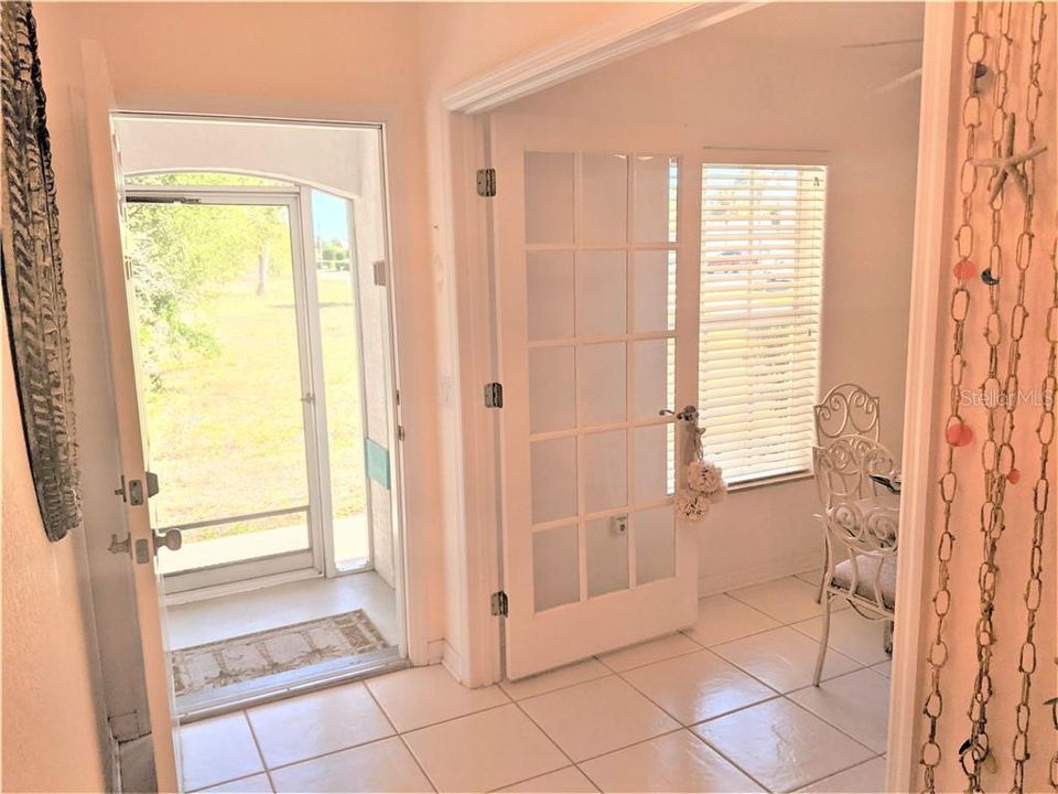as soon as you open the front door, the foyer is tiled and is opening via french door to a good size room which could be a den, a formal dining room or whatever owner decide