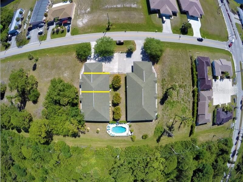drone picture showing well the 2 entrances to the community and the privacy of the pool backyard