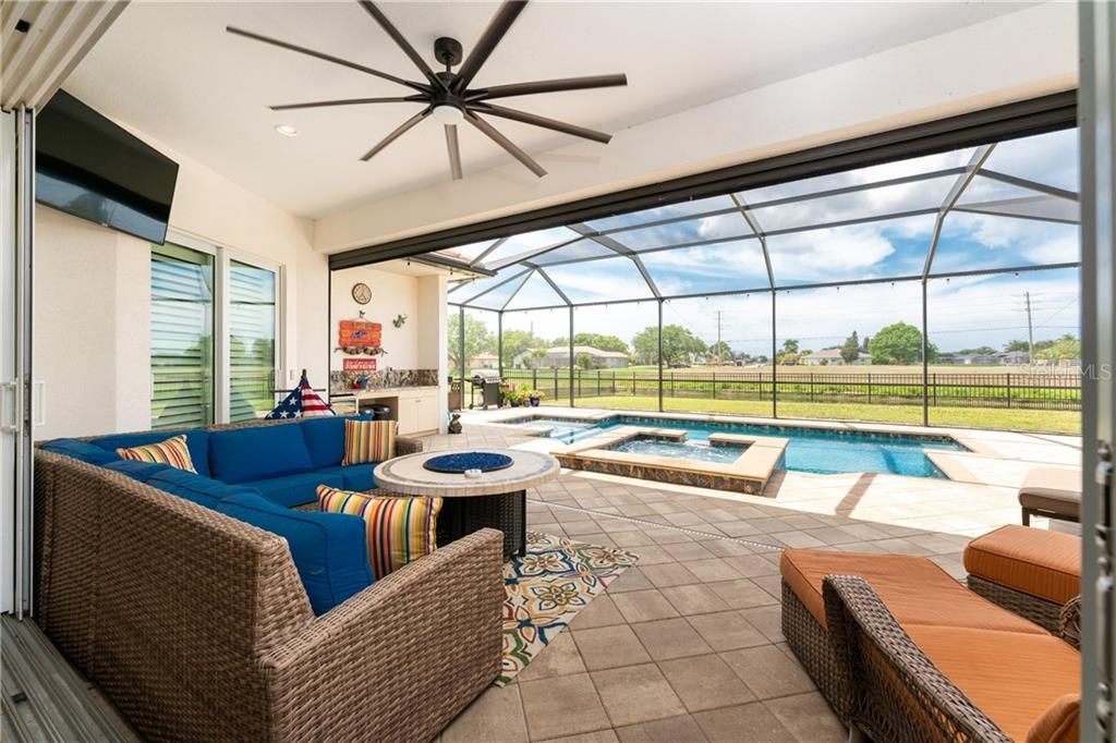 In the unlikely even of inclement weather, an automatic Kevlar screen can be closed to protect the lanai.  All other windows in the home are impact resistant windows for added protection.