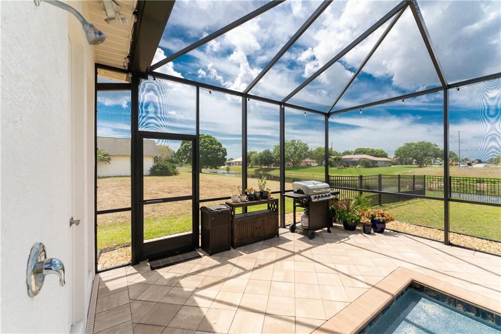 An outdoor shower is located poolside to help knock the sand off after returning from the beach.