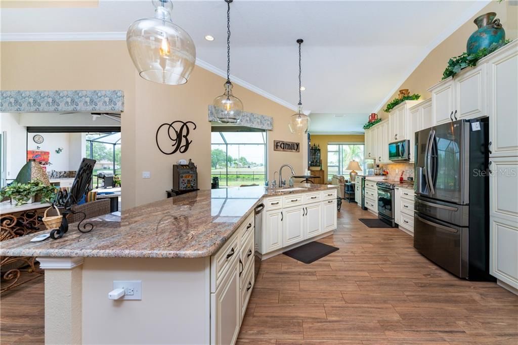 The beautiful kitchen is a natural gathering spot in this gorgeous home.