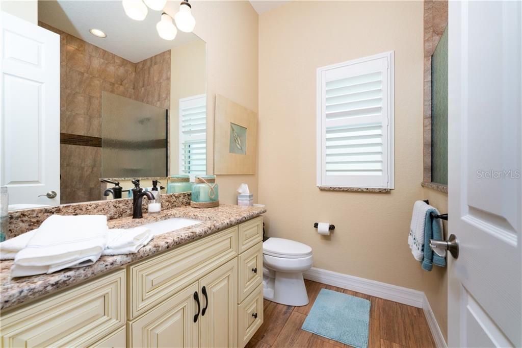 This guest bath is shared by bedrooms 2 and 3.  It offers a large walk-in shower.