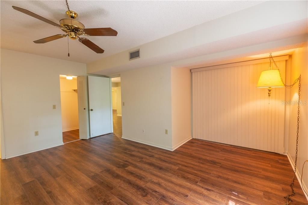 This shows the "sitting" area in the master bedroom.  Seller had a full-size couch in this area.  The walk in closet can be seen to the left of the entrance door.