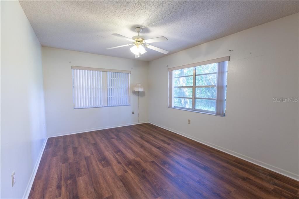 This is the 2nd bedroom located at the front of the unit.  Note the extra side windows on this end unit.  Beautiful wooded views are on the sides and rear of this condo.
