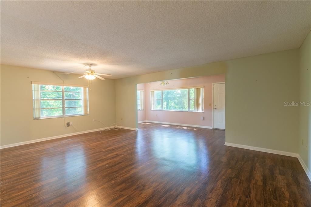 Note the corner unit extra windows that show the lush landscaping.  This living room is quite large and open.