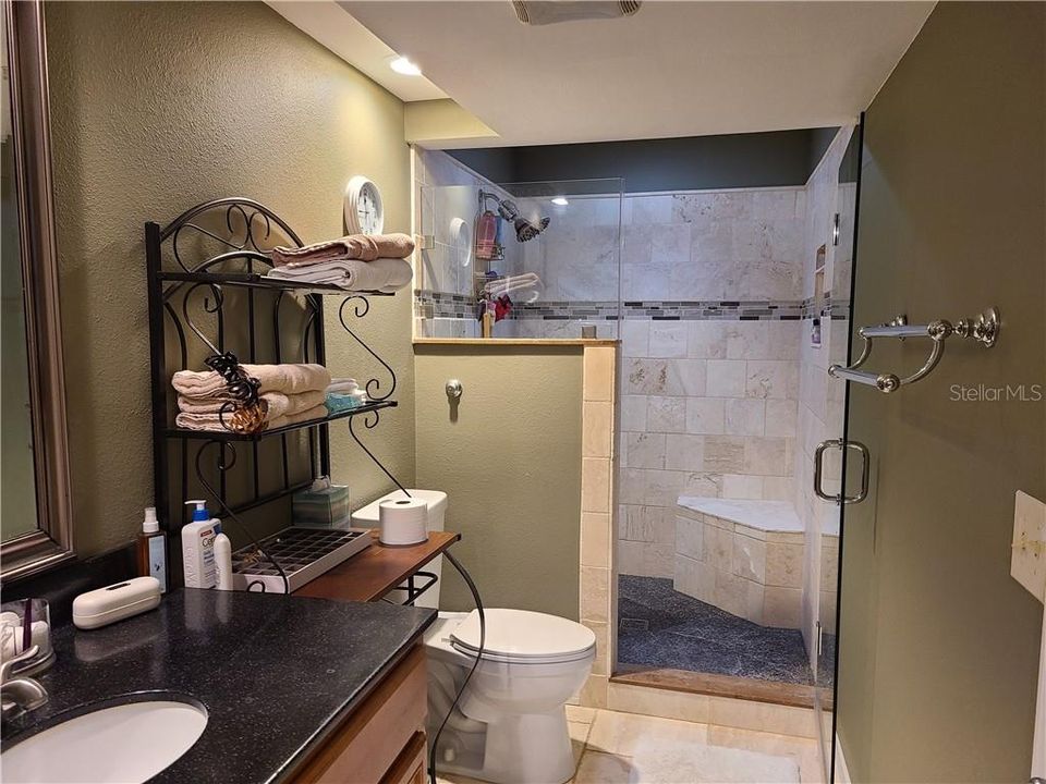 Master bath with updated beautiful oversized walk-in shower with sitting bench