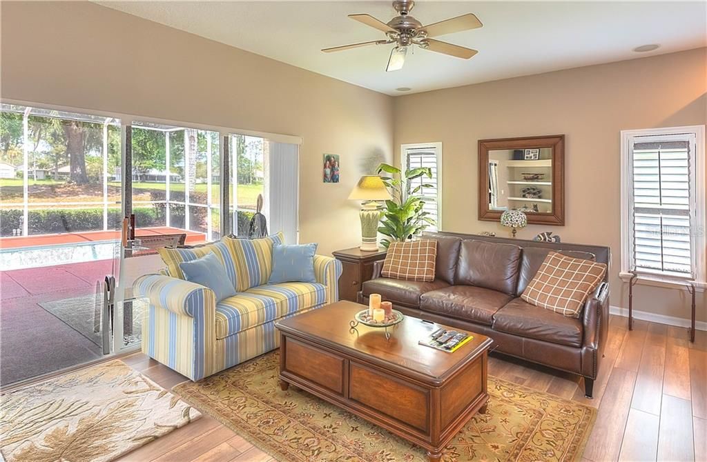 Living room shares space with the kitchen & opens to the screened lanai with views of the 14th fairway!