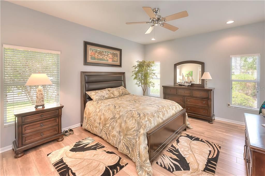 The king-sized Master Bedroom has updated wide plank laminate floors, access to the heated Plunge Pool & lanai & a ceiling fan.
