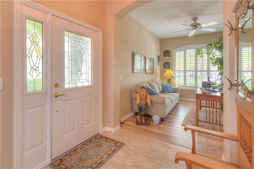 Beveled glass front door & side light welcome you into the foyer.  The living room with updated wide plank laminate floor can also double as a home office or den!