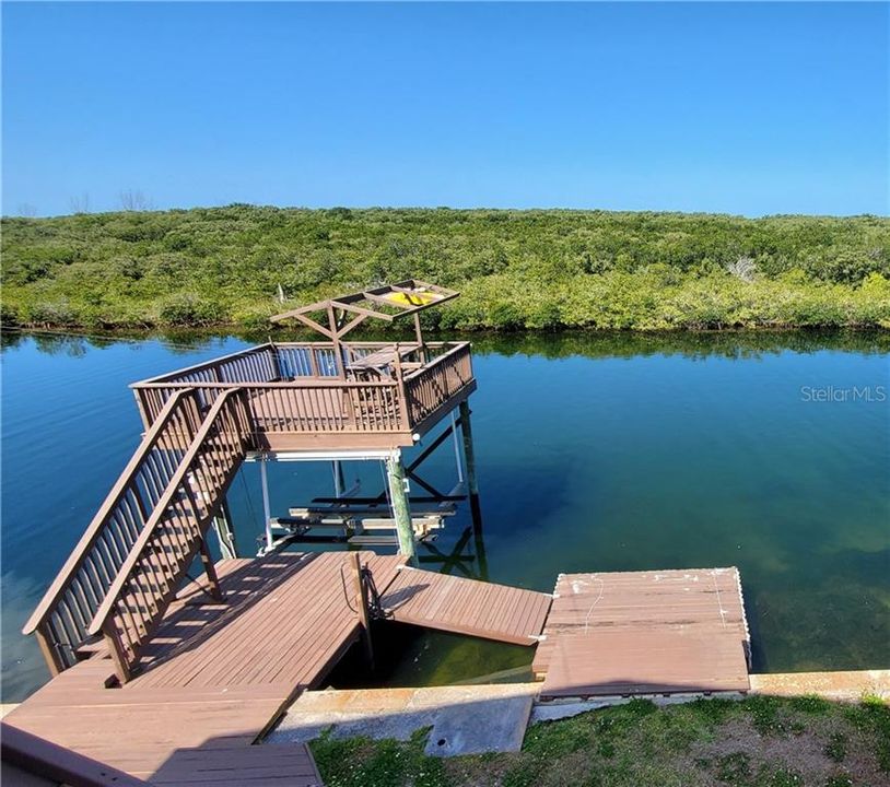 Boat Lift, Deck above with gate to jump off, decking over water and on land. Floating dock and deck over for extra entertaining area.