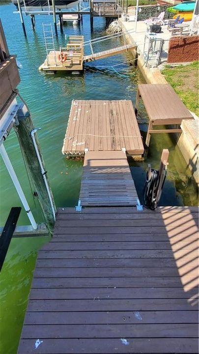 Decking leads to a floating dock and decking next to it.