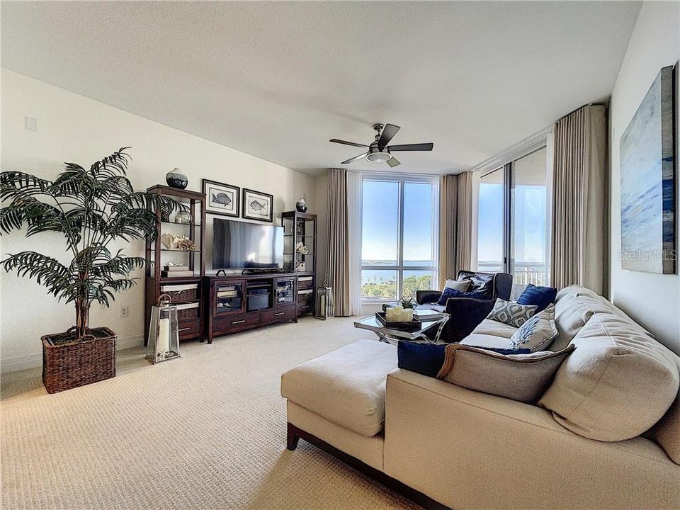 The living room with floor to ceiling windows and slider to the balcony and your water views.