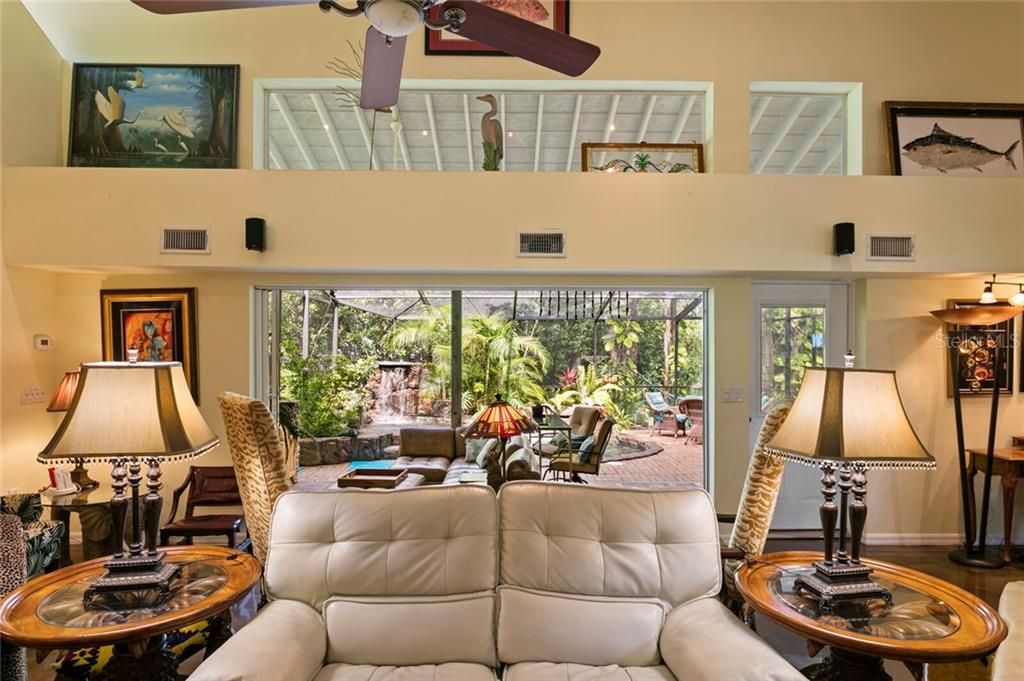 The triple sliding doors lead from the family room out to the pool & screened lanai