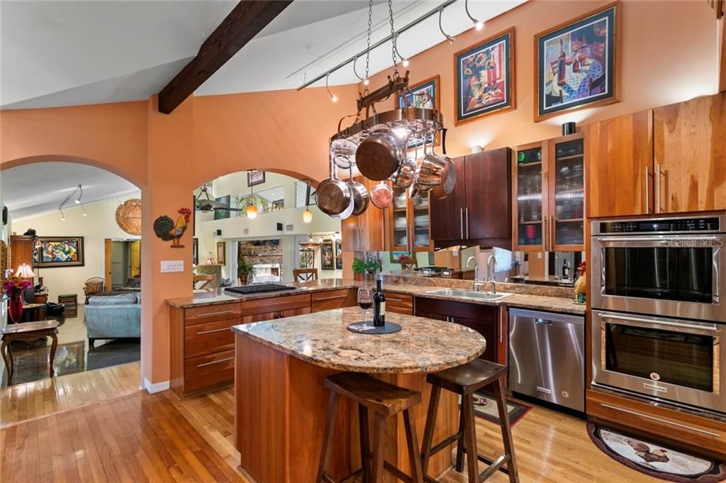 Custom solid Cherry wood cabinets & stainless appliances make for an elegant kitchen