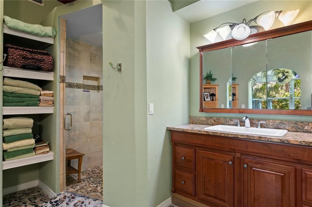 Views of the frameless glass walk-in shower in the Master Bath