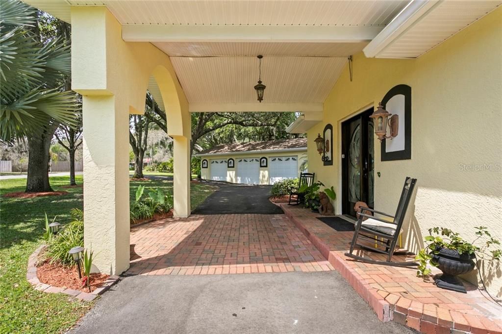 The brick entry leads to the custom wood double doors