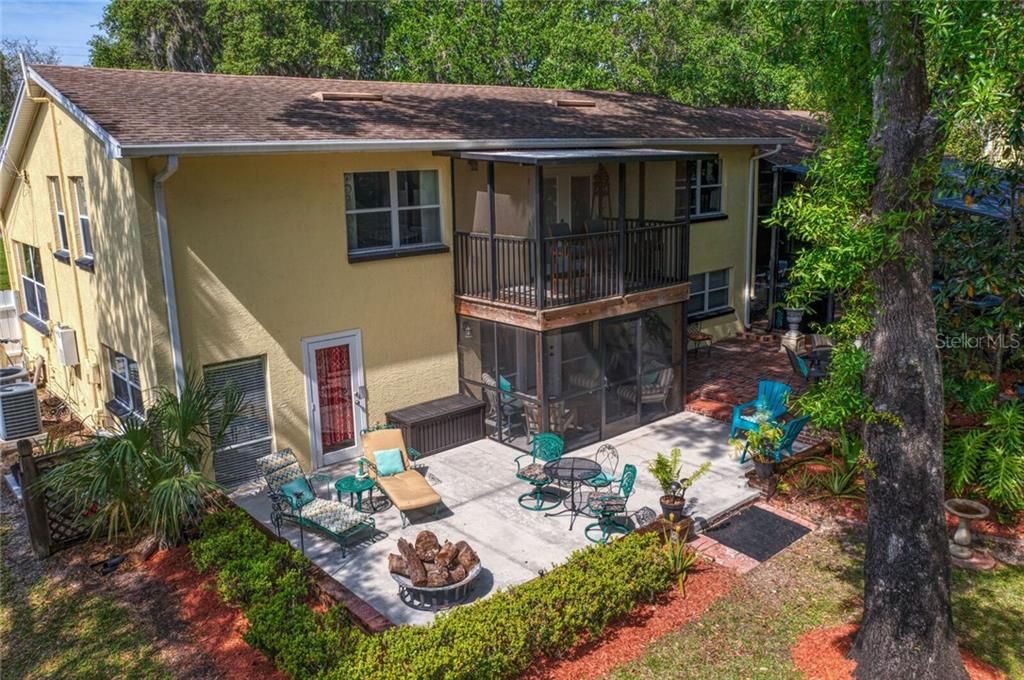 Views of the double-decker screened porches and backyard patio space