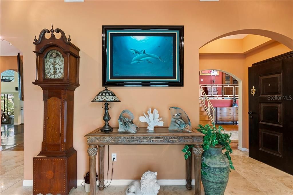 The welcoming foyer features travertine floors