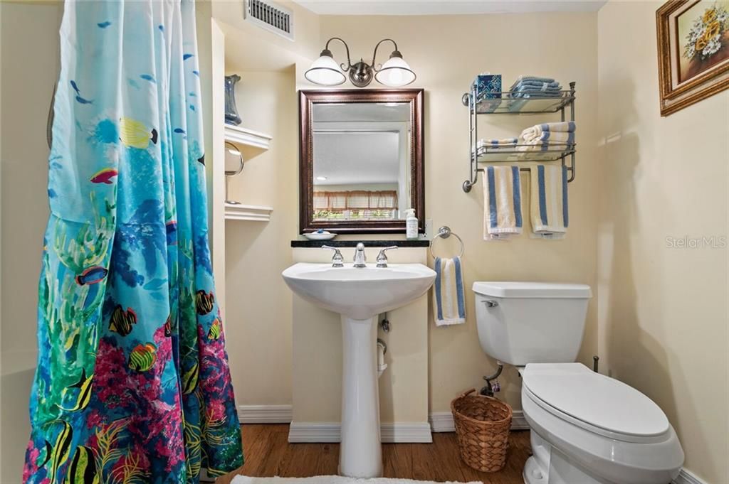 The ensuite bath in Bedroom 4 features a shower & pedestal sink