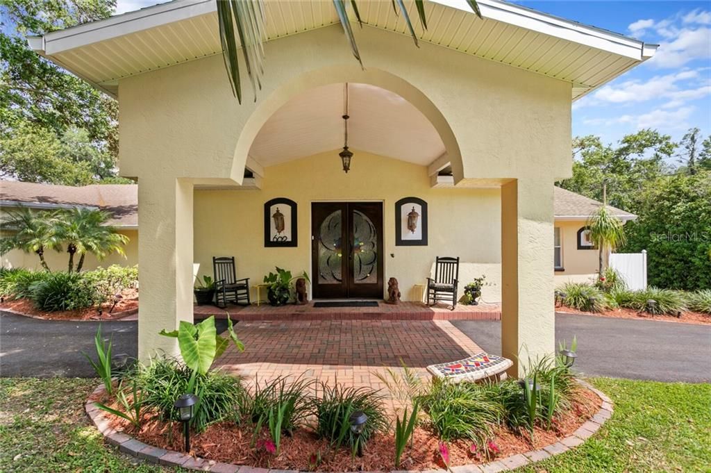 The port cochere provides an elegant covered entry