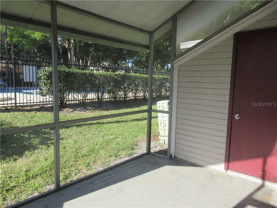 Enjoy morning coffee from your private screened porch with vaulted ceiling; storage closet