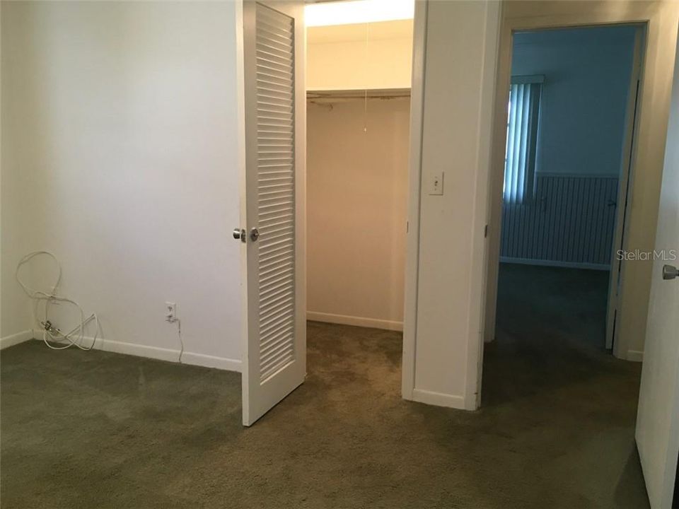 Master bedroom walk-in closet and door to hallway.
