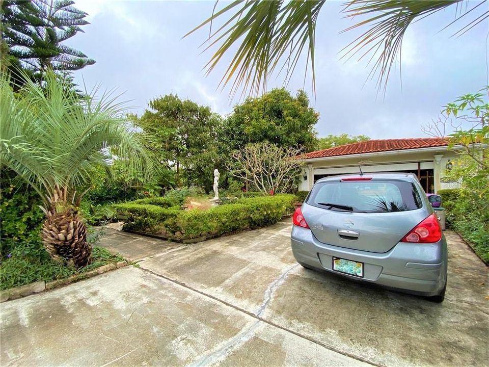 Double car driveway with private entry through lushly landscaped front yard