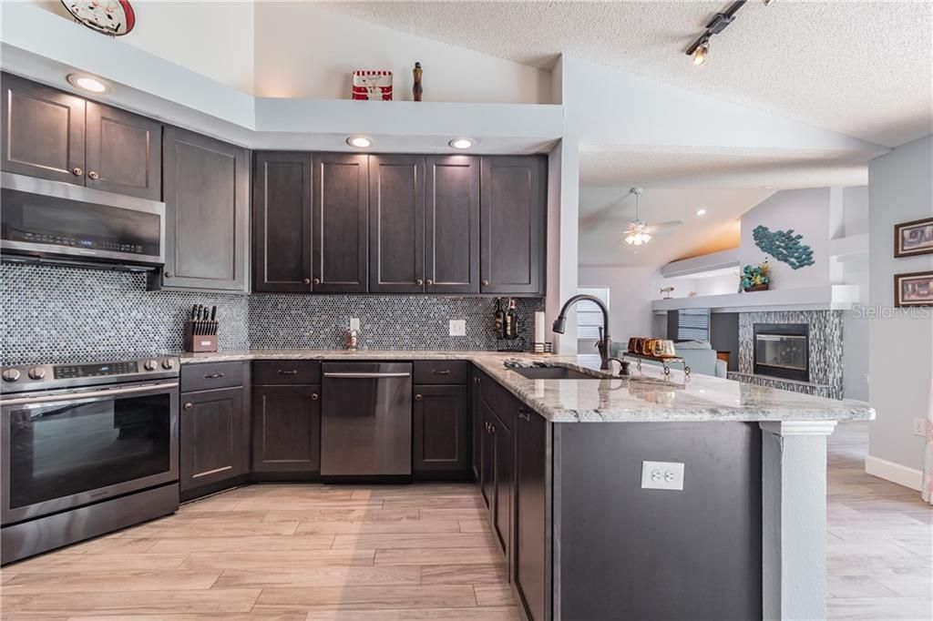 THE KITCHEN OPENS TO THE FAMILY ROOM, HAS IT'S OWN BREAKFAST NOOK THAT OPENS TO THE POOL AND THE FLORIDA ROOM AND OPENS TO THE DINING ROOM AS WELL