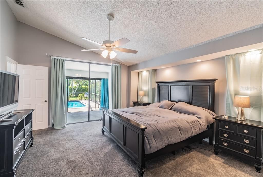 MASTER SUITE WITH ACCESS TO THE FLORIDA ROOM AND POOL