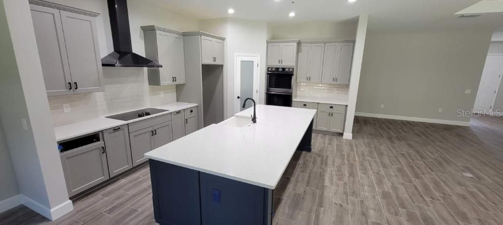 Gourmet Kitchen with wall ovens and cooktop.