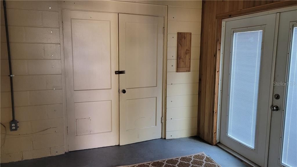 Inside front entry, doors to laundry room, side doors go to side yard.