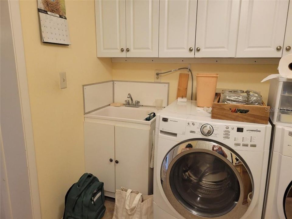 Laundry room has washer & dryer and do convey and an extra basin for cleaning.