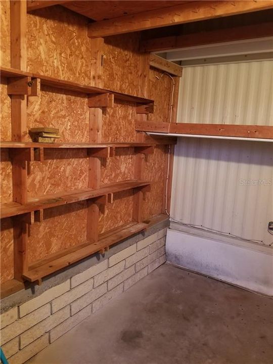 Shed showing storage area with shelves.