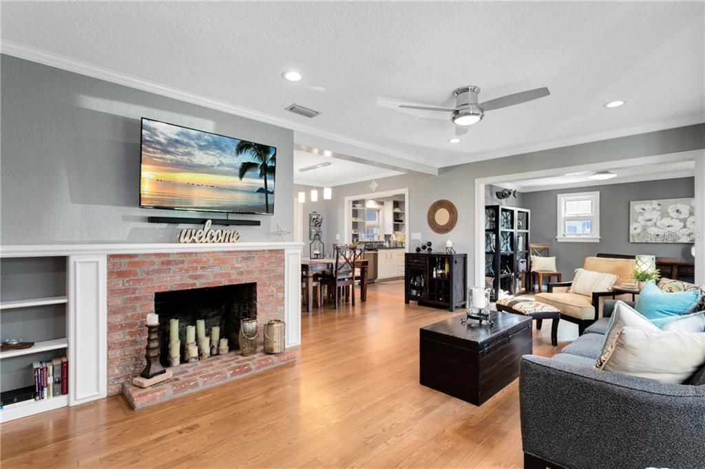 Entry view of your cozy home boasting hardwood floors and fireplace with an open floor plan concept.