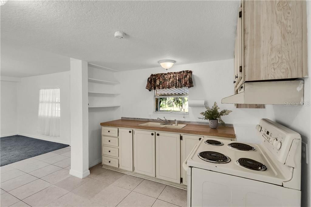 Kitchen Features Ivory Cabinetry & Built in Shelves